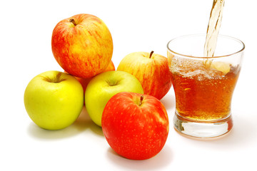 apples over white with filled glass
