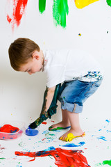 Child painting and getting evry messy
