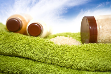 cream bottles and bath salt on the towels