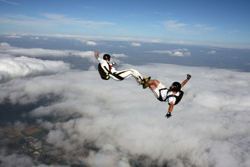 Two Skydivers in a sit position while in freefall