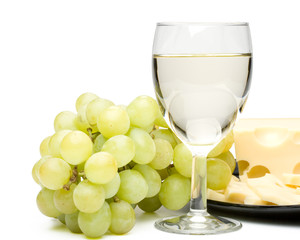 Wine in a glass, grapes and cheese