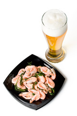 Beer in a glass and a dish with shrimps