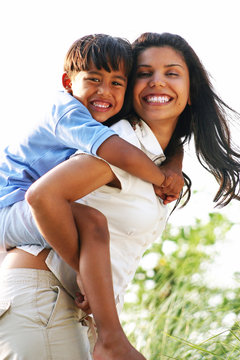 Mother Playing with Son with Piggyback Ride
