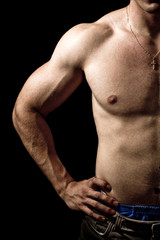 Naklejka premium Muscular guy on black background