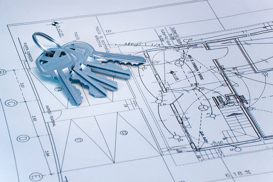 blue tone image of keys over some technical drawing