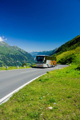 Bus on a road in Alps
