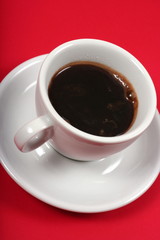 stimulating coffee cup on red background