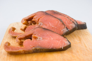 Slices of red fish on chopping board