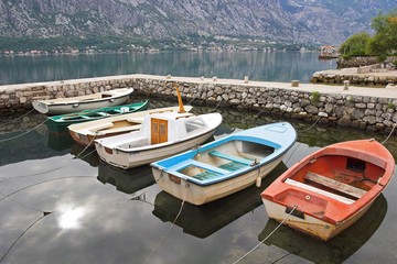 Fototapeta na wymiar Six fishing boats in harbor, Boka Kotorska bay