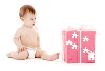 baby boy in diaper with big puzzle gift box