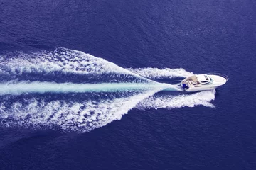 Fototapeten fast motor boat with splash and wake © Miroslav Beneda