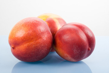 three nectarins on the table