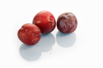 three plums on table