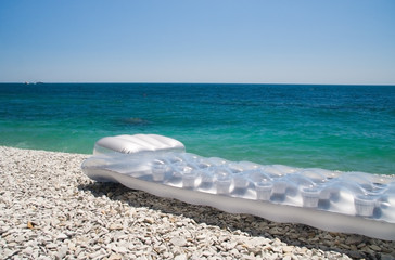 Fototapeta na wymiar inflatable mattress on on the beach sea