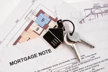 Keys on mortgage note and blueprints - 8786767