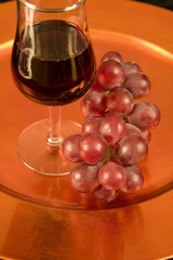 Red wine and red grapes on a tray