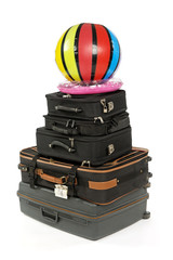 luggage with ball and  rubber ring isolated on a white