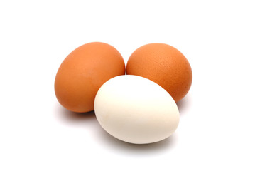 Three chicken eggs on a white background largly