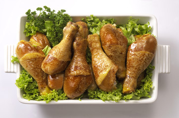some roasted chicken legs over lettuce