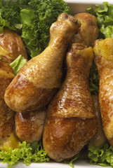 some roasted chicken legs over lettuce