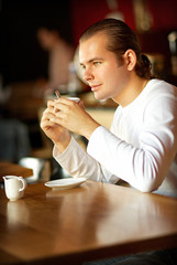 Cup of coffee and young man