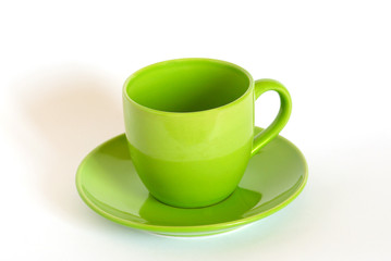 Green tea cup and saucer isolated on white.