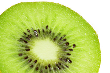 Macro photo of sliced kiwi fruit with seed.
