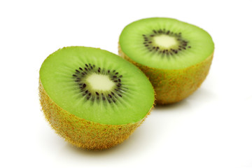 A kiwi fruit sliced into half on white background.