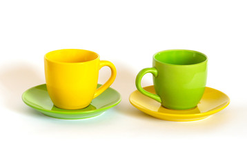 Two colored tea cups and saucers isolated on white.