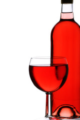 bottle and glass of fruity rose wine, backlit