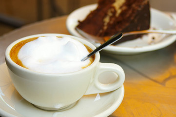 cup of coffee and a piece of chocolate cake