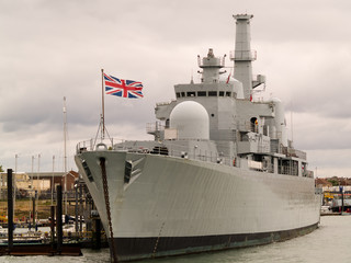 British war ship tied alongside.