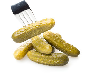 Crackling pickled gherkins on a plug on a white background