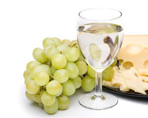 Wine in a glass, grapes and cheese