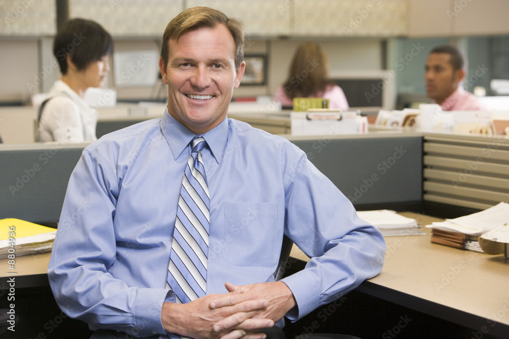 Sticker Businessman in cubicle smiling