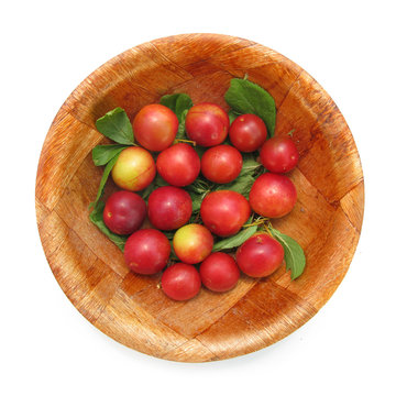 Wild plums in wooden dish