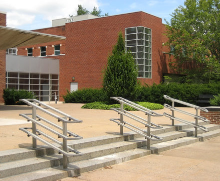 University building brick facade with steps and front walkway.