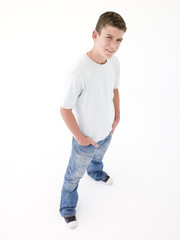 Fototapeta premium Teenage boy standing with hands in pockets