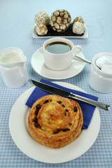 Delicious sultana danish pastry with a cup of black coffee