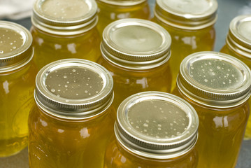 Mason jars filled with clear sweet honey.