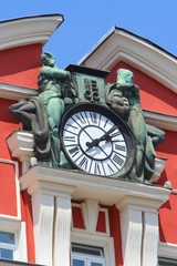 Old clock ona red house