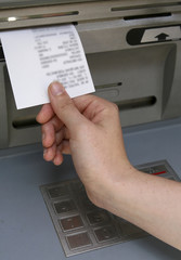 Hand taking a receipt of an Automated Teller Machine