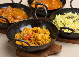 Indian curries in authentic black steel korai dishes