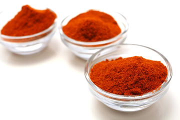 three red hot paprika bowls isolated over white