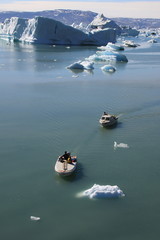 Two hunters drive their boats to the shore
