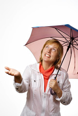 Middle years woman under the umbrella  looks rain