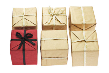 Red color gift box alone among brown boxes on white background