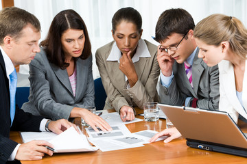 Portrait of confident people looking at business papers