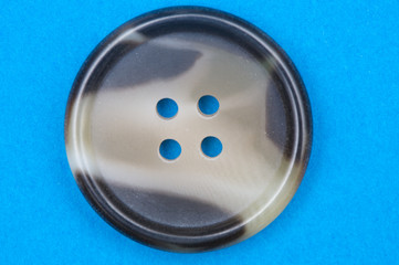 nice button with four holes on a blue background
