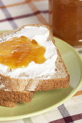 Toast and jam with shadow on background. Shallow depth of field